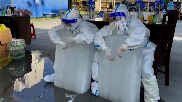 see-why-health-workers-in-china-are-hugging-giants-blocks-of-ice